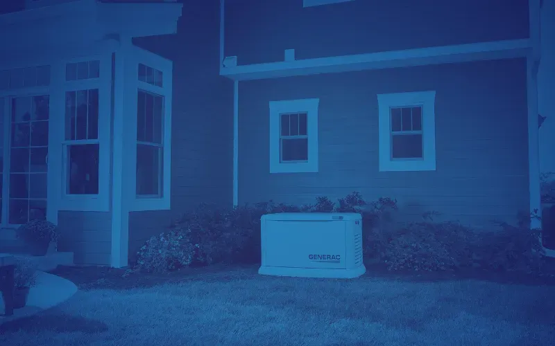 A stand-alone Generac generator is placed on the grass outside a house with siding. Two windows and shrubs are visible, creating a calm residential setting.